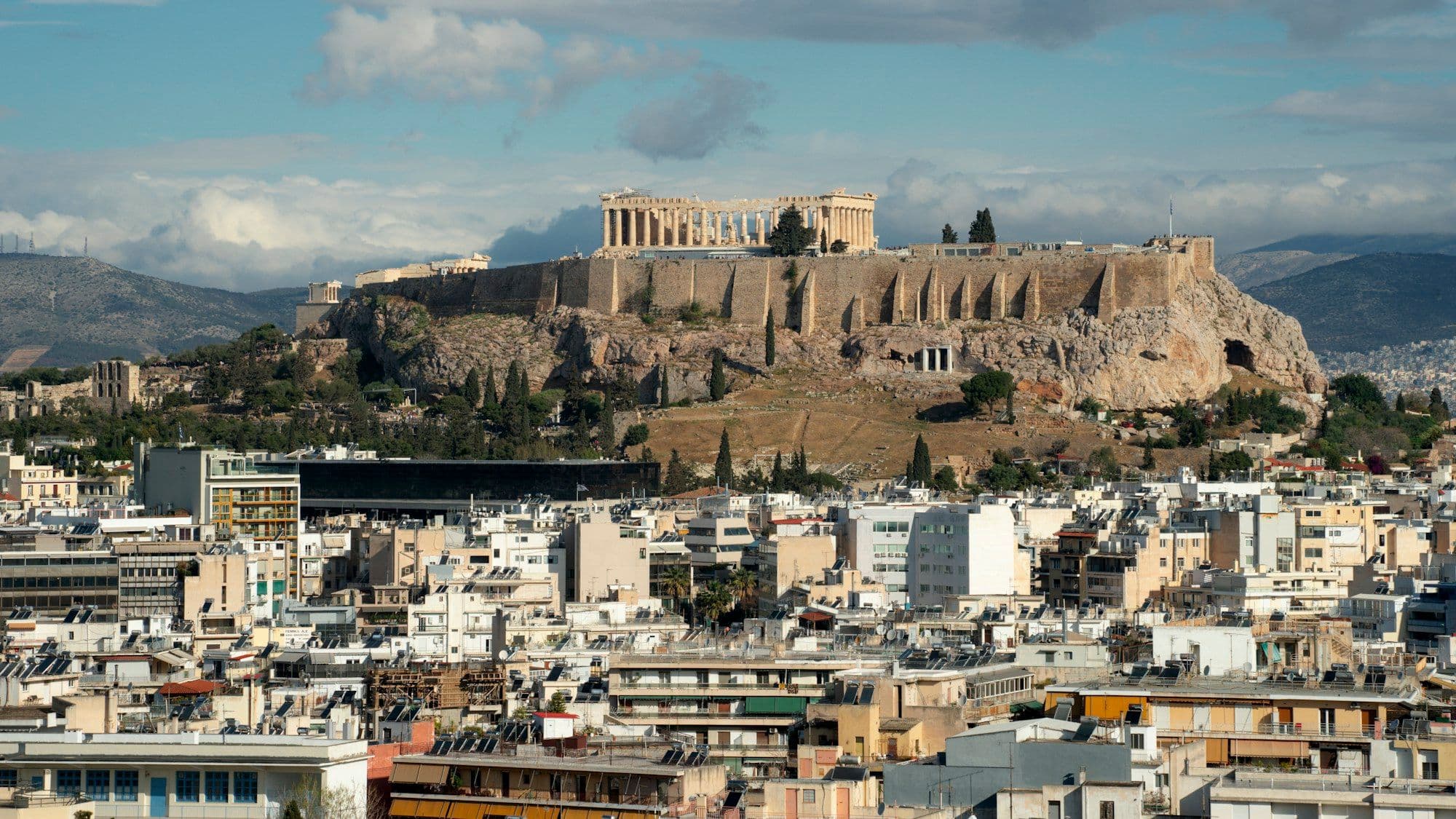 The Acropolis of Athens overlooking dense urban neighbourhoods